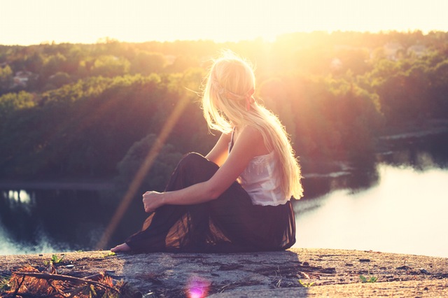 Woman waiting for sun to set during DST